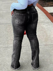 Close view of flare jeans showing distressed knee openings and a raw split hem.