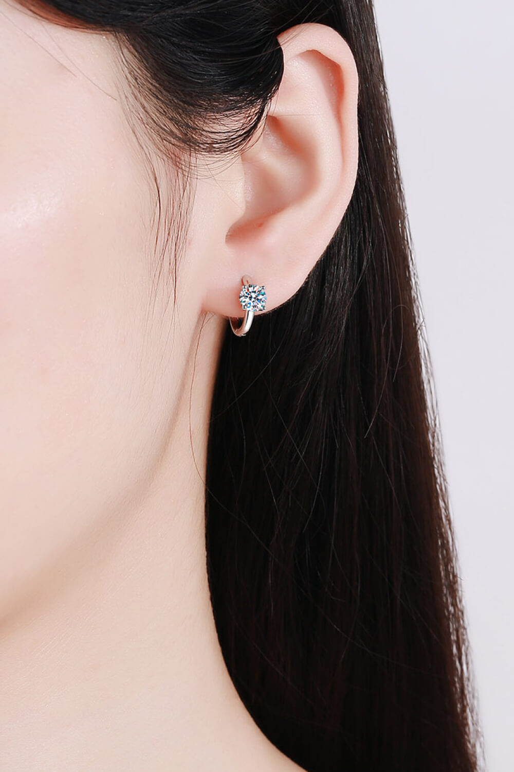Moissanite huggie hoop earrings worn on ear