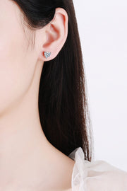 2 Carat Moissanite Heart-Shaped Stud Earrings — Heart-shaped moissanite studs worn on an ear