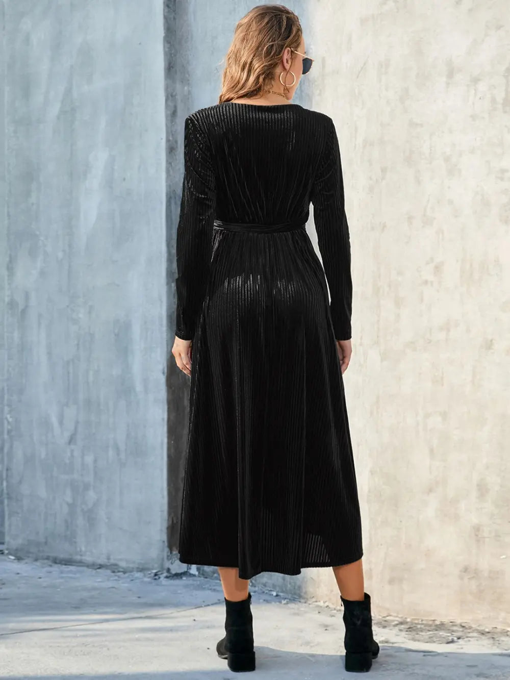 Back view of black long-sleeve dress with tie waist