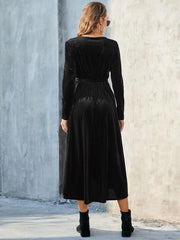 Back view of black long-sleeve dress with tie waist