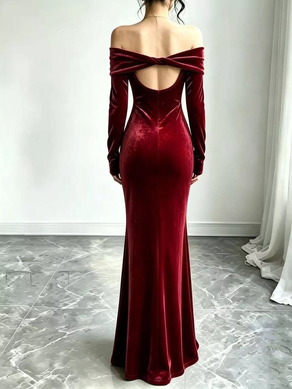 Burgundy velvet dress showing the low open back and mermaid skirt