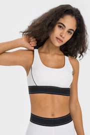 Front view of white contrast sports bra with black racerback straps