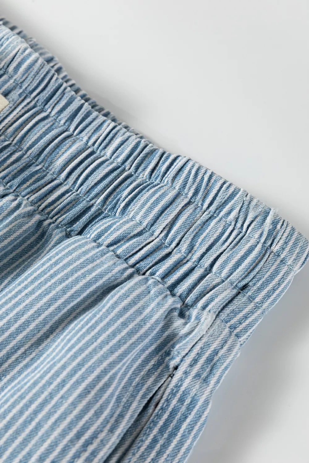 Close detail of the fine blue-and-white stripes and elastic waistband.
