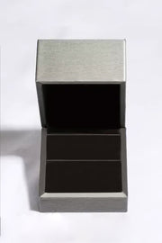 Open grey jewellery presentation box with dark lining