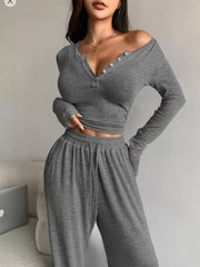 Close front view of dark grey button-neck cropped top and matching drawstring pants