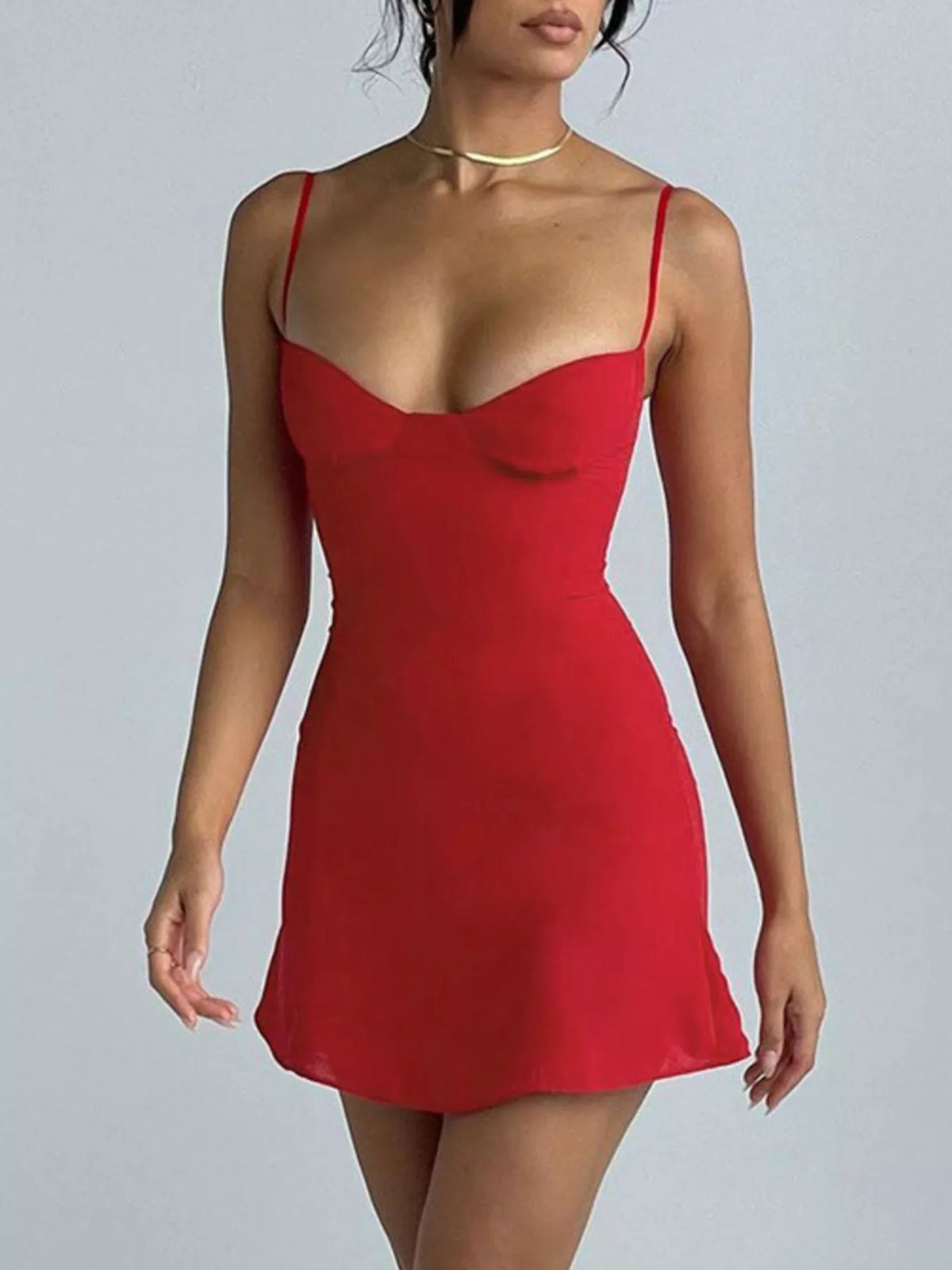 Model wearing the red sweetheart-neck mini dress with a fitted bodice and short skirt.