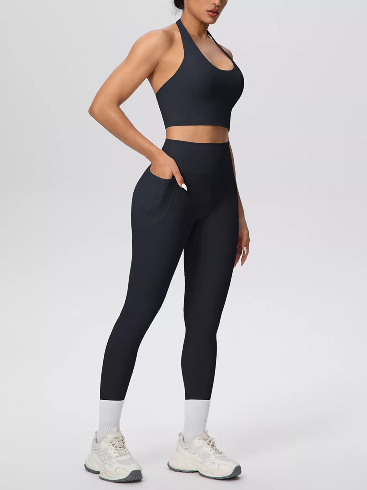 Black halter crop top and leggings shown in a close front pose