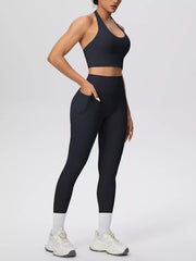 Black halter crop top and leggings shown in a close front pose