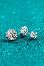 Close-up of moissanite stud and butterfly back on teal background