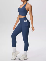 Side view of blue halter activewear set with phone pocket