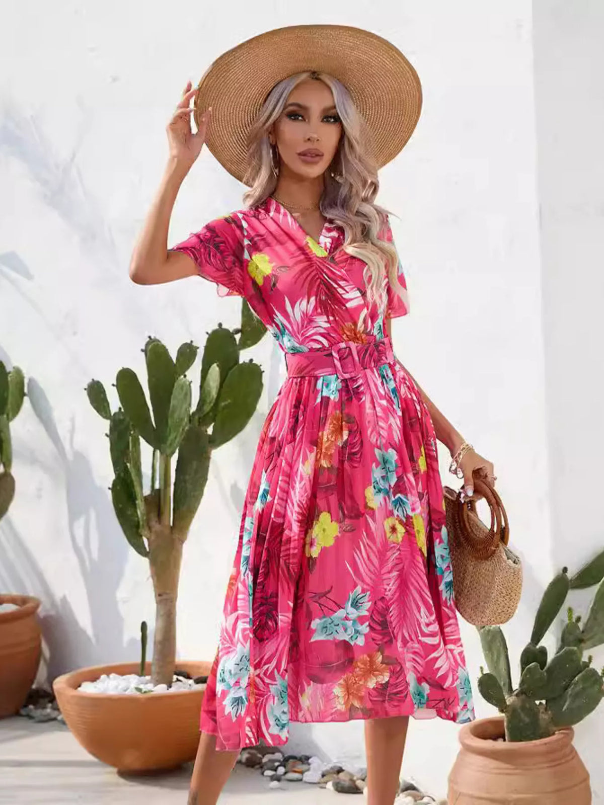 Hot pink tropical print belted midi dress, angled view