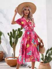 Hot pink tropical print belted midi dress, angled view