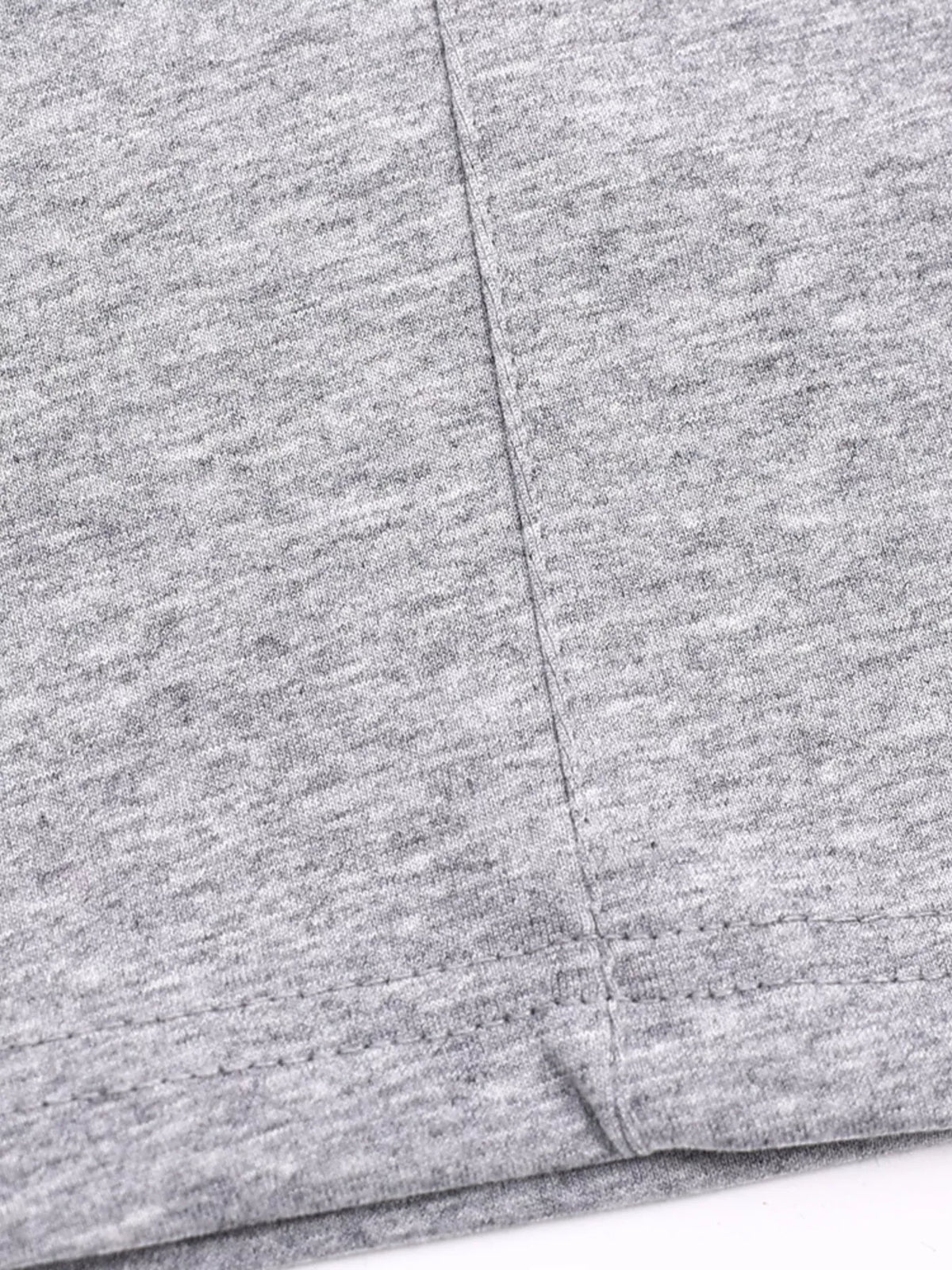 Detail of gray T-shirt shoulder seam and soft knit fabric