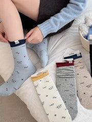Several colors of cartoon-print crew socks shown together