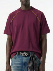 Model wearing burgundy short-sleeve T-shirt with contrast shoulder piping