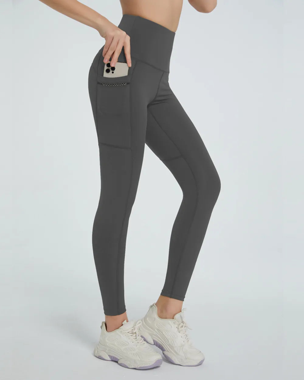 Dark gray high-waisted leggings with side pocket, shown from side