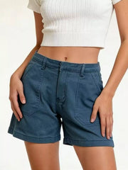 Angled front view of blue patch-pocket denim shorts with a white crop top