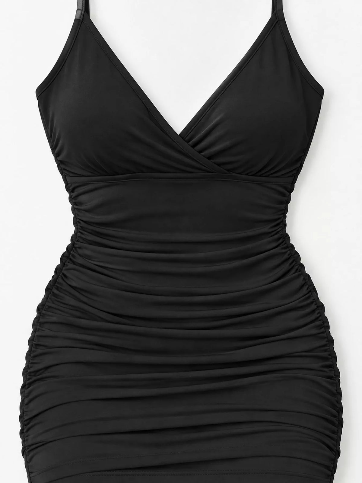 Close view of the black dress's crossover bodice and gathered waist and hips.