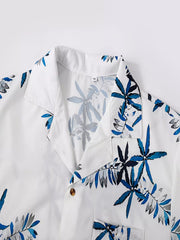 Close-up of the open collar and buttons on the tropical-print shirt