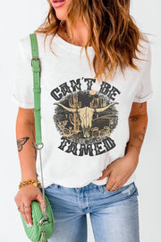 Model wearing white graphic tee with green shoulder bag