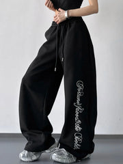 Black wide-leg drawstring pants with white script leg print