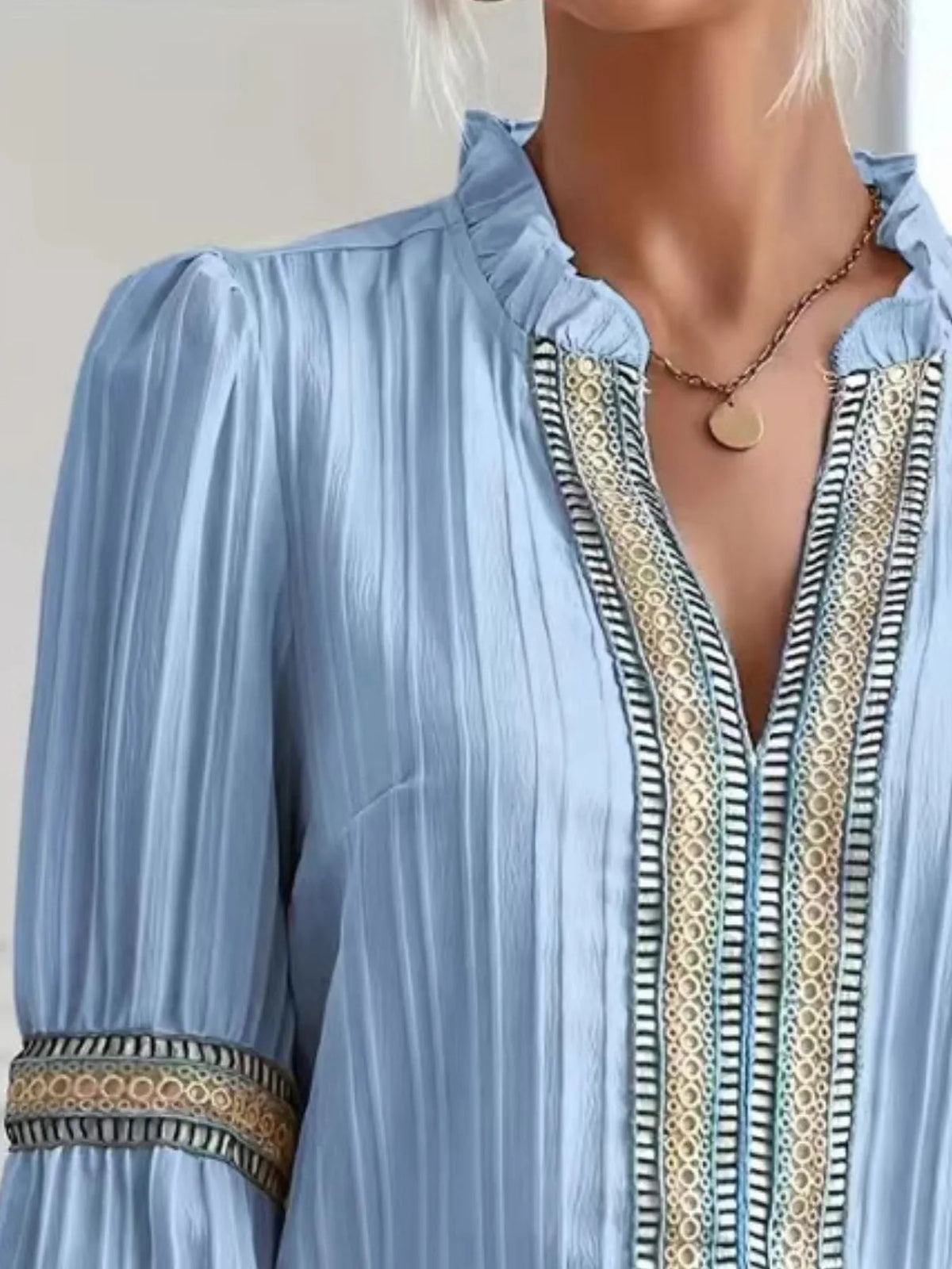 Notched textured balloon-sleeve blouse in blue neckline detail