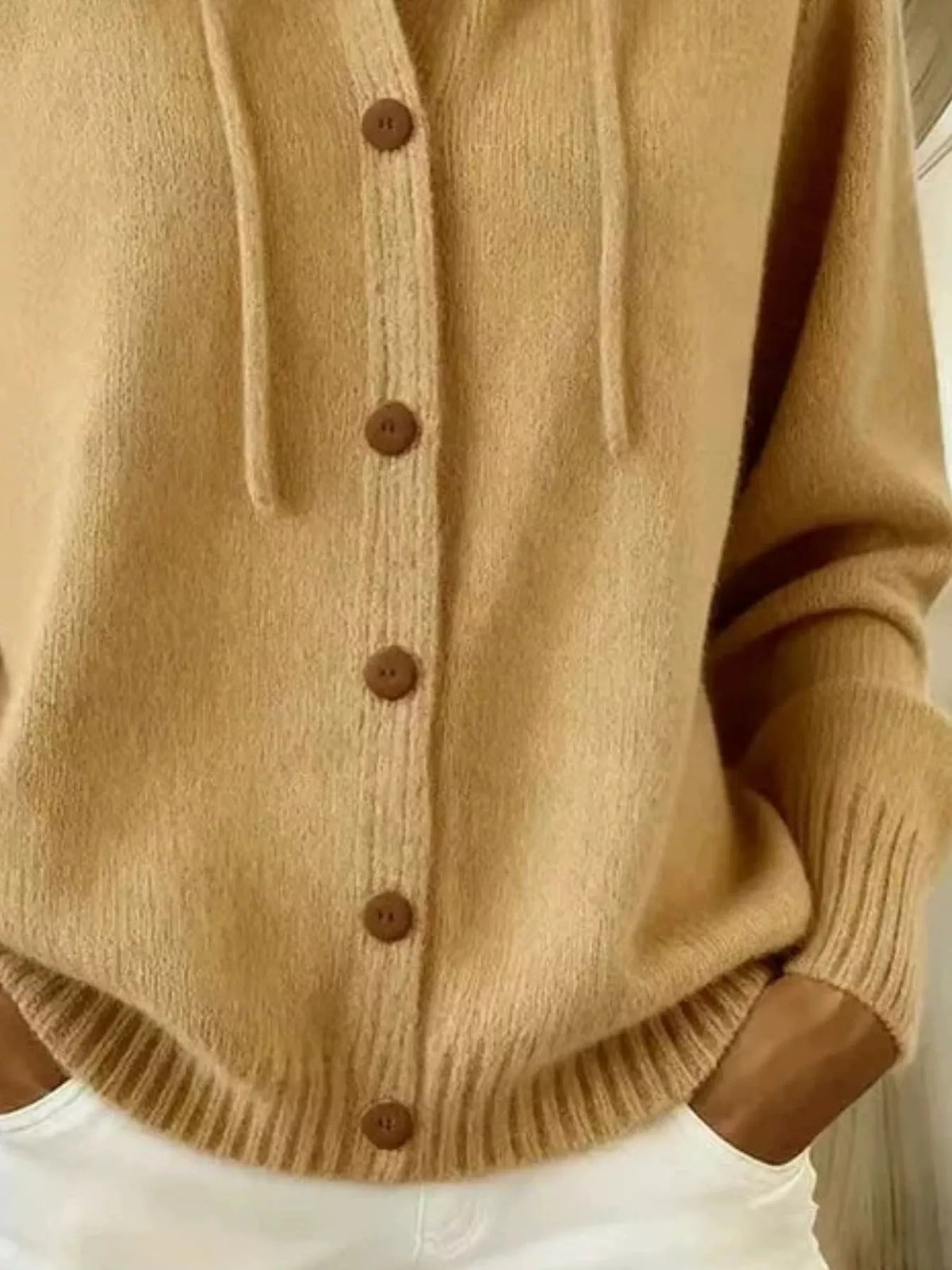 Close view of tan cardigan hood and button placket