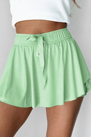Front view of mint green skort with gathered waist and center tie