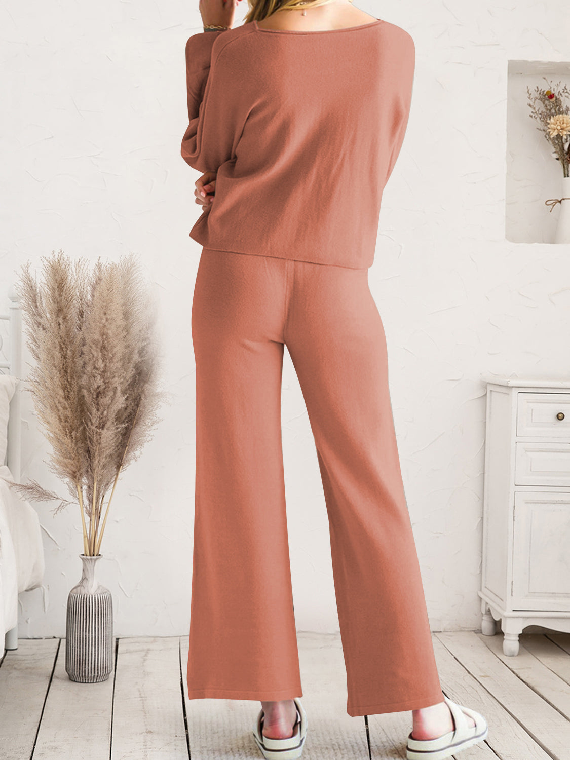 Rust-colored wide-leg lounge pants shown from waist to hem