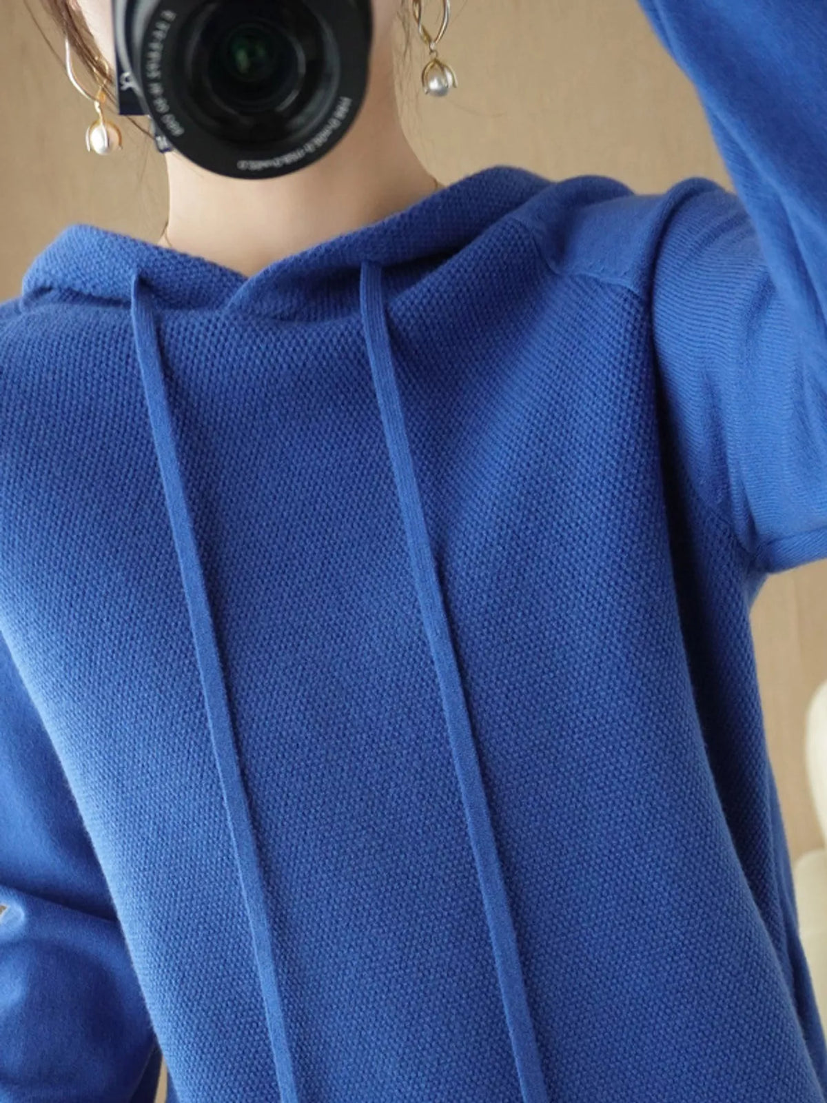 Royal blue hooded knit sweater shown in a close front mirror photo.