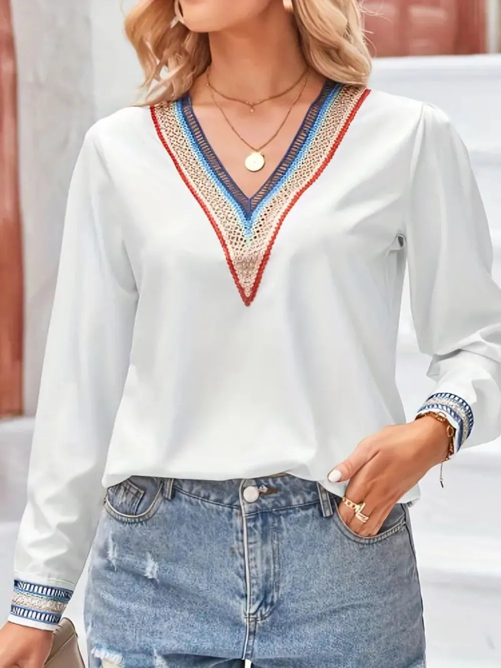 Contrast V-neck long-sleeve blouse in white front pose with hand at hip