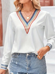 Contrast V-neck long-sleeve blouse in white front pose with hand at hip