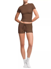 Front view of brown ribbed mock-neck crop top and matching shorts on model