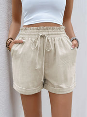 Front view of cream shorts showing ruffled leg hems