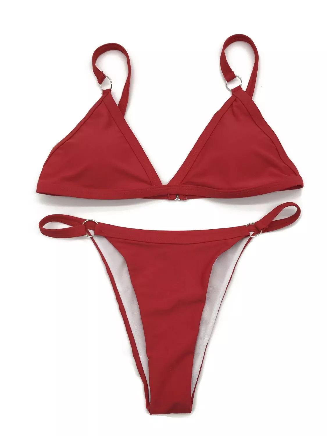 Model wearing a red ring-detail bikini in front of a striped wall