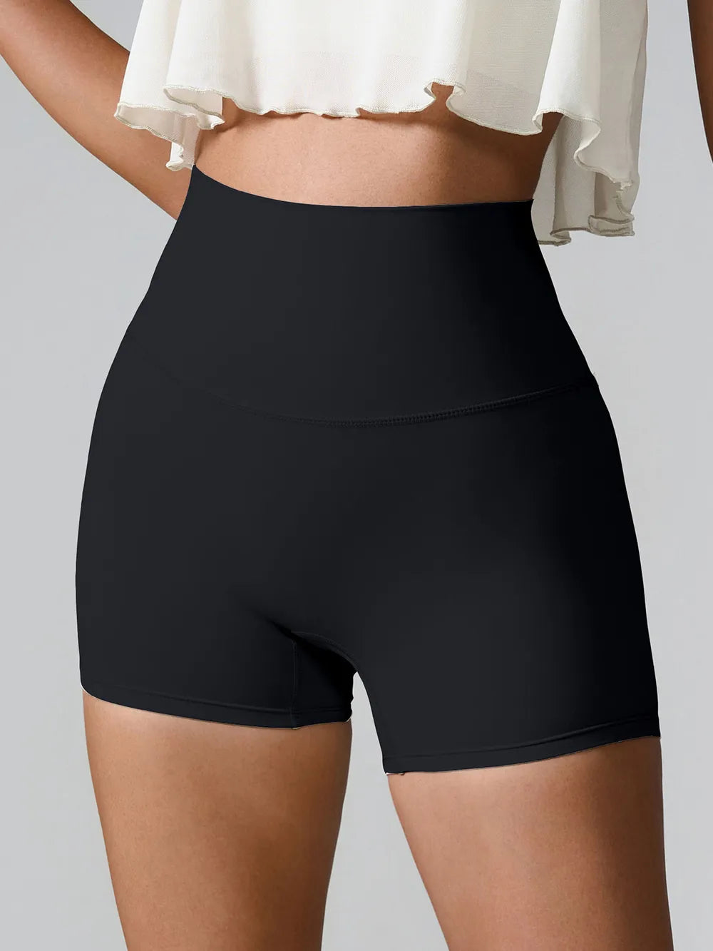 Front view of black high-waist fitted active shorts.
