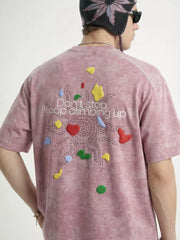 Back view of washed pink graphic T-shirt with colorful hearts