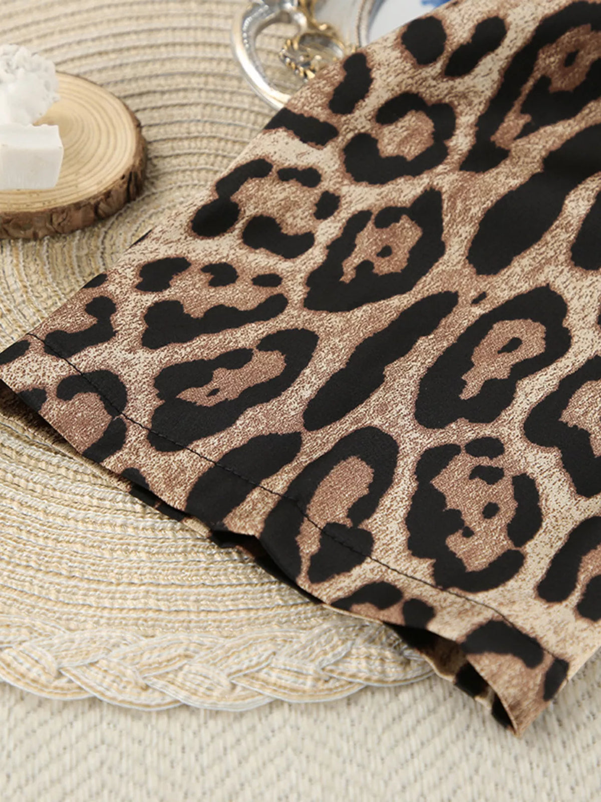 Close-up of leopard-print shorts hem and layered edge