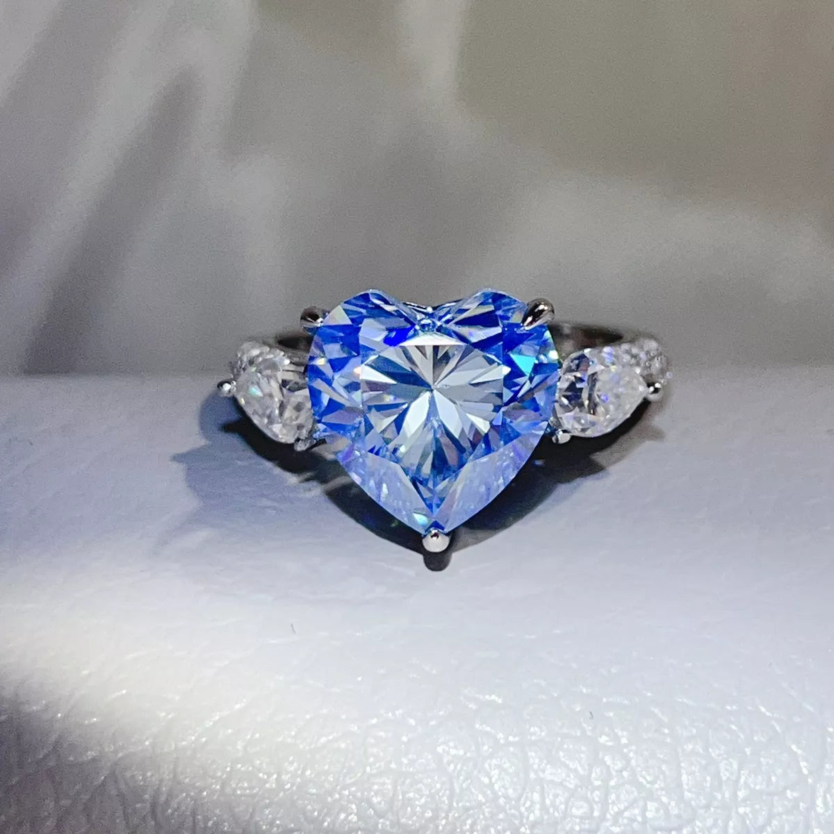 Blue heart-shaped moissanite ring shown from the front.