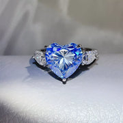 Blue heart-shaped moissanite ring shown from the front.