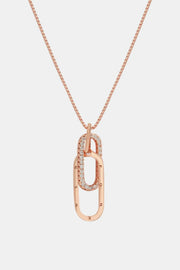 Rose gold-tone open rectangular pendant necklace on white background