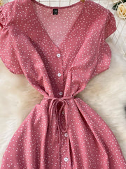 Pink polka-dot dress close-up of buttons and tie belt