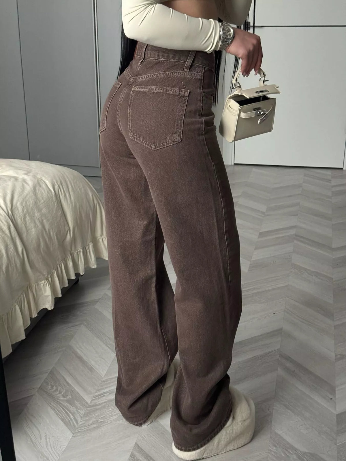 Rear three-quarter view of brown wide-leg jeans