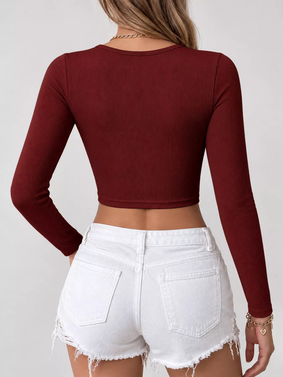 Back view of a burgundy long-sleeve cropped top