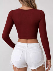 Back view of a burgundy long-sleeve cropped top