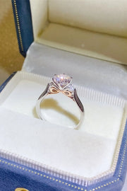 Purple-stone ring in a cream-lined box showing the curved band