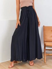Model wearing black wide-leg pants, front view