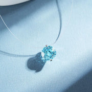 Close view of a pastel-blue round zircon pendant on a fine silver-tone chain