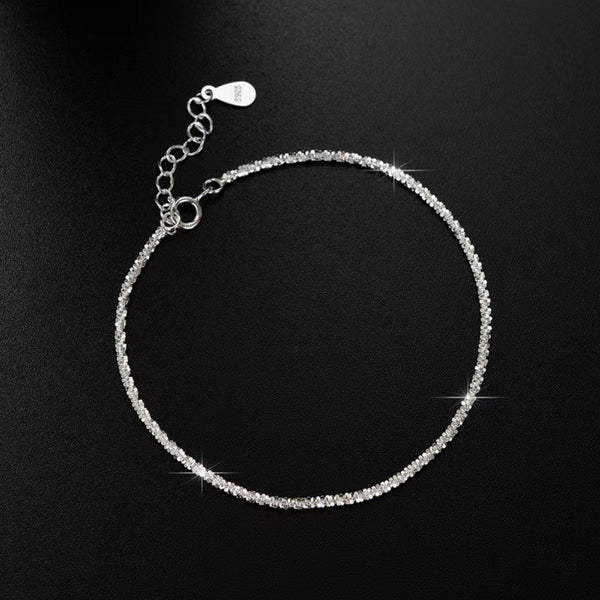 Adjustable sterling silver chain bracelet with extension and clasp on black